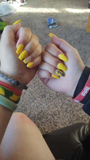 Yellow coffin nails with custom art at L.A. Nails